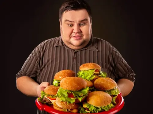 depositphotos 180387998 stock photo fat man eating fast food